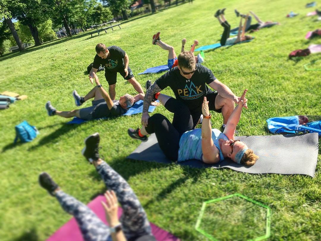 Peak Performance outdoor bootcamp class training together in the park