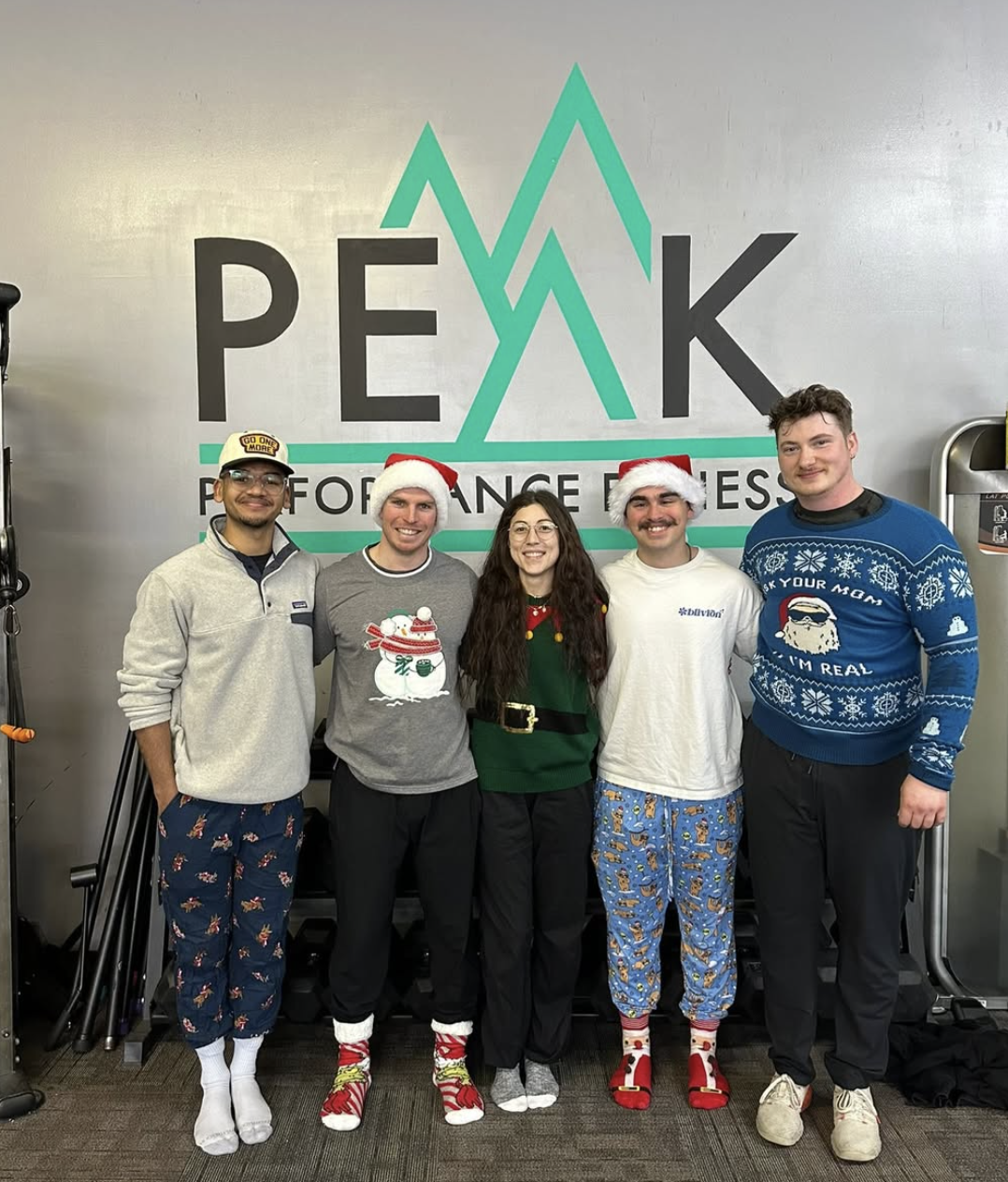 Peak Performance members in holiday pajamas together at the gym